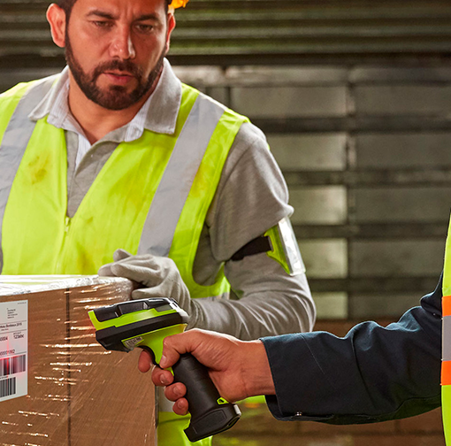 a man in a safety vest scanning a box