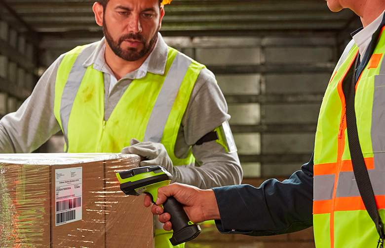 a man in a safety vest scanning a box