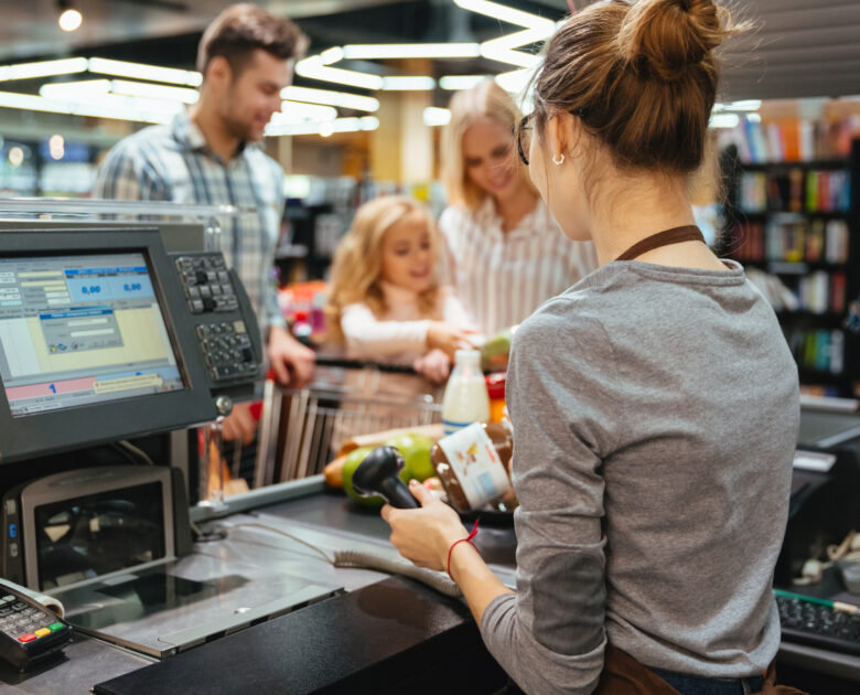 a woman at a cashier with scanners