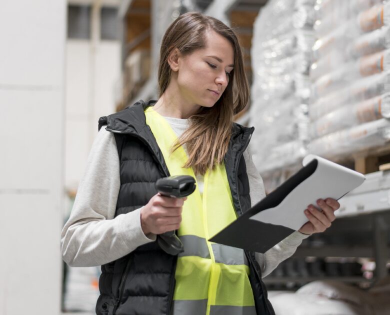 a woman holding a barcode scanner and a clipboard